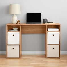 a wooden desk with two drawers and a laptop on it