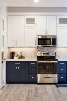 a kitchen with white cabinets and blue drawers