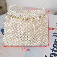 Brand Name: MR.YLLSShape: FLAPHandbags Type: Shoulder BagsTypes of bags: Shoulder Crossbody BagsOrigin: CN(Origin)Main Material: BeadedClosure Type: OPENHardness: HARDExterior: NONEStyle: FashionModel Number: Z-YY869Occasion: VersatileGender: WOMENPattern Type: SolidNumber of Handles/Straps: SingleInterior: No PocketDecoration: PearlDecoration: BeadingItem Type: HandbagsNAME: Luxury Pearl Women's bags Braided beads bagsNAME 2: Pearl small flap bagWomen's Bag: women pearl bagShoulder Bag: pearl b Pearl Bags, Holographic Bag, Beaded Fashion, Top Lingerie, Wedding Bags, Bag Badges, Small Messenger Bag, Banquet Party, Beaded Boxes