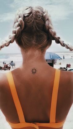 a woman with a sun tattoo on her back