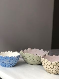 three bowls sitting on top of a white counter