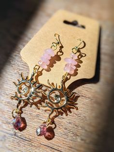 Handmade Rose Quartz gold dangle Sun Swirl earrings.☀️✨🔆 The perfect accessory for the sun goddess in your life. Lightweight for comfortable every day wear. Rose Quartz stones, brass gold plated sun pendants, & crystal tear drop beads dangling on 18k gold plated hypoallergenic fish hook earring wire. Handmade with love! 💗🌸 **I started my crystal suncatcher business in 2022 in memory of my soulmate fur-kitty, Peep, who absolutely adored the sunshine. He was the sunshine of MY life, so in his honor, I create beautiful pieces that capture the sun he loved so much. Thank you for supporting my business Pink Stone Jewelry, Sun Goddess, Accessories Boho, Quartz Pink, Crystal Suncatcher, Earring Wire, Rose Gold Quartz, Handmade Rose, Rose Quartz Earrings