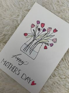 a mothers day card with pink flowers in a vase on a white furnishing