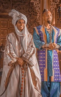 two men standing next to each other in costume