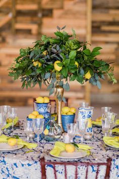 a table set with lemons and blue dishes