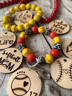 wooden keychains with baseballs and softball balls on them