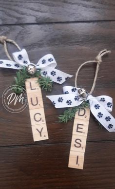 two wooden tags with dog paw prints on them and the words lucky tied to them