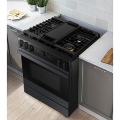 a black stove top oven sitting inside of a kitchen next to a counter with utensils on it