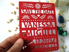 a person holding up a red card with the words save the date on it