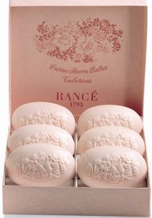 six white soaps in a pink box on a white surface with the words range printed on them