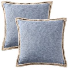 two light blue pillows with beaded trims on the sides and one in front