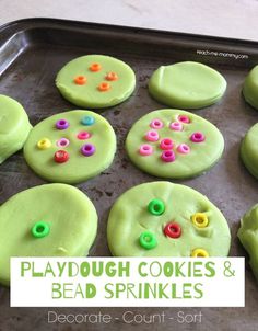 playdough cookies and bead sprinkles on a baking sheet with text overlay