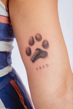 a person with a tattoo on their arm that has a dog's paw and the word fried