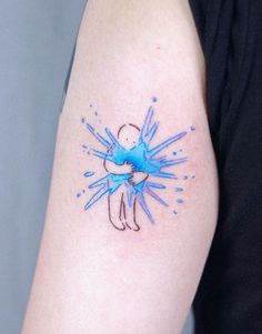 a blue ink splattered tattoo on the arm