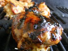 grilled chicken and other meats cooking on an outdoor grill