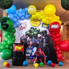 the balloon arch is decorated with balloons and other decorations for an avengers birthday party at home