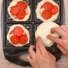 someone is making mini pizzas in an air fryer