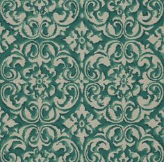 a green and white rug with an ornate design