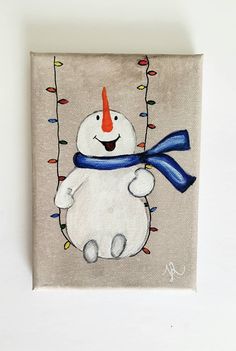 a painting of a snowman wearing a red nose and blue scarf with christmas lights on it