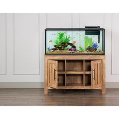 a fish tank sitting on top of a wooden cabinet