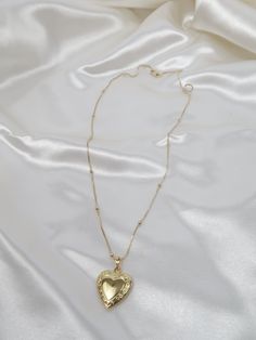 Vintage meets dainty. This heart locket is pure perfection! Add your favorite photo to hold to your heart forever. Length: 18in, 20in Pendant: Size : 27mmx19.2mm Model wearing 20in Dainty Heart Pendant Locket Necklace For Keepsake, Dainty Double Heart Necklace As A Keepsake, Heart-shaped Locket Necklace With Heart Charm For Memorials, Heart Shaped Locket Necklace With Heart Charm For Memorial, Heart Charm Memorial Locket Necklace, Dainty Open Heart Locket Necklace For Keepsake, Dainty Double Heart Locket Necklace, Dainty Heart Cut Locket Necklace, Memorial Heart Charm Locket Necklace