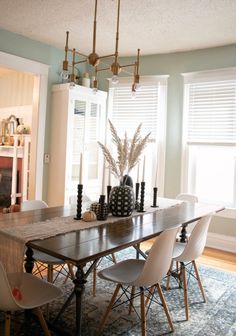 a dining room table with white chairs around it