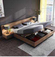 a bed that is sitting on top of a wooden platform in a room with gray walls