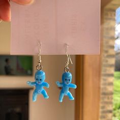 a pair of blue teddy bears hanging from earrings