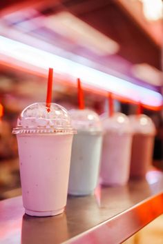 three drinks sitting on top of a metal counter