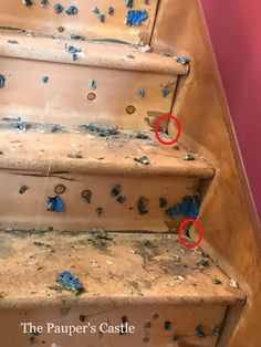 two red circles are on the bottom of an old set of stairs that have been painted blue