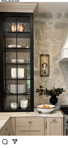 a kitchen with an oven, cabinets and plates on the counter top in front of it