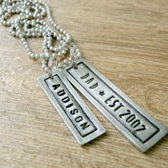 "PLEASE leave a cell # in the personalization box so we can text if we have questions. Thanks Our father's day necklace is trendy and ready for any season. It's hand stamped one letter at a time. DETAILS: Lg. Pewter Bar w/ Border = 1.75\" x .5\", reads '--> DAD * EST. YYYY' (You provide the year.), Shown in Lollipop font Sm. Pewter Bar w/ Border = 1.25\" x .38\" and reads up to 9 characters of your choice Ball Chain = aluminum, 24\" (you can cut it shorter if desired), black and brown leather Fancy Gifts, Mens Items, Metal Letters, Bar Pendant, Necklace Personalized, Ball Chain, Metal Stamping, Name Necklace, Leather Cord