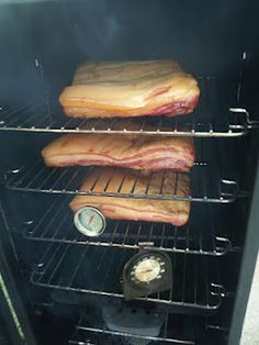 some meat is cooking in an oven on top of other food items and it's time to cook