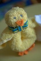 a small yellow stuffed animal sitting on top of a table