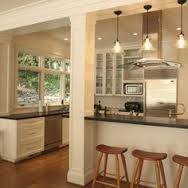 a kitchen with three stools next to an island