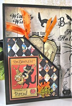 a close up of a card with an orange ribbon on it's edge and some other cards in the background