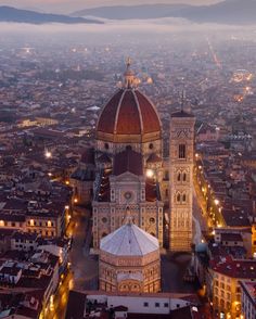 an aerial view of a large cathedral in the middle of a city at night time