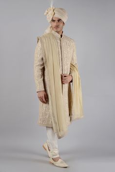 Gold floral embroidered sherwani crafted with dori and zari work. Paired with golden kurta and churidar. 
Component: 3
Pattern: Embroidered
Type Of Work: Dori, zari work
Neckline: Mandarin
Sleeve Type: Full Sleeves
Fabric: Raw Silk
Color: Gold
Other Details: 
Floral motifs
Note: Stole and head accessory worn by the model is not for sale
Occasion: Groom, Wedding - Aza Fashions Semi-stitched Gold Kurta With Naqshi, Gold Chanderi Sherwani For Wedding, Gold Sherwani With Dupatta In Raw Silk, Elegant Gold Chanderi Sherwani, Gold Raw Silk Dupatta With Naqshi Detail, Gold Raw Silk Dupatta With Naqshi Embroidery, Gold Naqshi Raw Silk Dupatta, Gold Semi-stitched Chanderi Sherwani, Ceremonial Raw Silk Sherwani With Naqshi