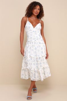 Bring all your crushes running whenever you step out in the Darling Attraction Ivory Floral Embroidered Tiered Midi Dress! This adorable dress boasts a lightweight woven construction, with a darling floral print and subtle embroidery-like details. Adjustable spaghetti straps support a bodice with a V-neckline, triangle cups, decorative buttons, and a pleated designâ€” all atop a drop waist. Tiered and ruffled skirt finishes at a midi hem. Hidden zipper/clasp at back. Fit: This garment fits true White Breezy V-neck Midi Dress, White Tiered Summer Dress, Beach Dresses With Ruffles And Mid-length, Beach Mid-length Dresses With Ruffles, Breezy Midi-length Dress Down Dresses, Mid-length Ruffled Dresses For The Beach, Summer Tiered Dresses With Floral Embroidery, Spring Breezy Ruched Midi Dress, Breezy Spring Midi Dress With Ruched Detail