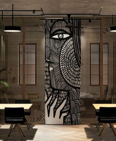 an artisticly designed wall in the middle of a room with wooden tables and chairs