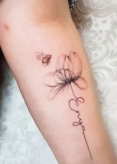 a woman's leg with a tattoo on it that says love and a flower