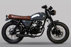 a black and brown motorcycle on a gray background