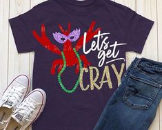 a t - shirt that says let's get cray on it next to jeans and sneakers