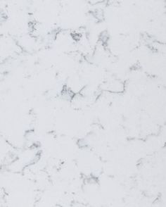 a white marble counter top with black dots on it