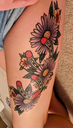 a woman's thigh with flowers on it