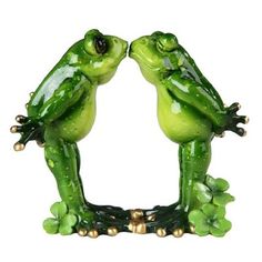 two green frog figurines sitting next to each other