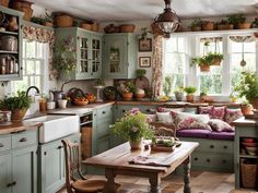 a kitchen filled with lots of green cupboards and counter top next to a window