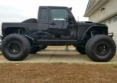 a black jeep parked in front of a house