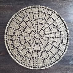 a white doily sitting on top of a wooden table