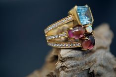 Ring wide: 0.75''/19.5mm Band wide: 0.37''-0.2''/9.8mm-5.2mm This statement ring is made of topaz, tourmaline, opal, diamond, and 18K gold. It's gorgeous and elegant. Perfect for any occasion. Thank you for your interest. Please check out our other items and be sure to add us to your favorites! We look forward to the opportunity of serving you. Formal Multi-stone Ruby Ring With Tourmaline, Formal Multi-stone Tourmaline Sapphire Ring, Formal Multi-stone Tourmaline Ruby Ring, Luxury Multi-stone Sapphire Ring With Tourmaline, Luxury Multi-stone Tourmaline Ring, Diamond Topaz Ring, Opal Diamond Ring, Multi Gemstone Ring, Gold Statement Ring